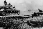 Anonymous - Germans tanks cross a river into Polish territory, September 1939