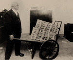 Anonymous - 105 billion marks for bread: A man carrying a wheelbarrow full of cash, Germany, 1923